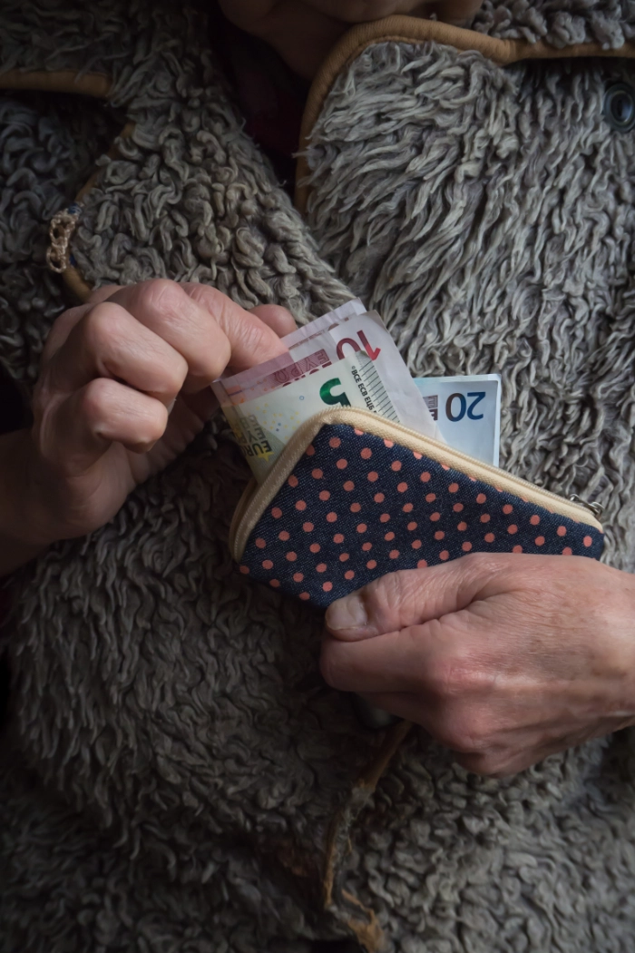 aow-uitkering geld in portemonnee oudere vrouw"